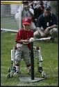 A slugger from Leedom Little League sets his mark during a game in the White House South Lawn Tee-Ball League Sunday, July 27, 2003. White House photo by Lynden Steele.