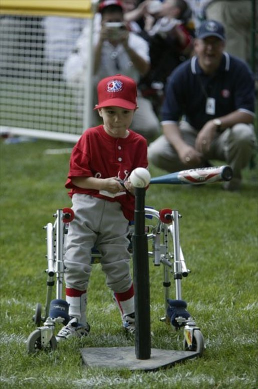 A slugger from Leedom Little League sets his mark during a game in the White House South Lawn Tee-Ball League Sunday, July 27, 2003. White House photo by Lynden Steele.