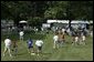 The bases are loaded with Tee-Ball players and their buddies during this season's second game of the White House South LawnTee-Ball League Sunday, July 27, 2003. Teams and families from Glen Burnie, Md., and Ridley Park, Pa., came out for tee-ball and picnic on the South Lawn. White House photo by Lynden Steele.