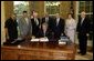 President George W. Bush signs the Burmese Freedom and Democracy Act in the Oval Office Monday, July 28, 2003. White House photo by Susan Sterner.