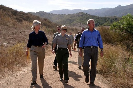 President George W. Bush walks with Secretary of the Interior Gale Norton, left, and Director of the National Park Service Fran Mainella at the Santa Monica Mountains National Recreation Area in Thousand Oaks, Calif. File photo. White House photo by Paul Morse.