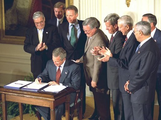 President George W. Bush signs the Chile and Singapore Free Trade Agreement Implementation Acts in the East Room Wednesday, Sept. 3, 2003. White House photo by Tina Hager.