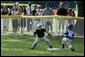 The first basemen from the Hamilton Little Lads Cal Ripken League of Hamilton, N.J., makes a play during a fast-paced game against the Milwood Little League of Kalamazoo, Mich., during the last game of the 2003 White House South Lawn Tee Ball season Sunday, Sept. 7, 2003. White House photo by Lynden Steele.