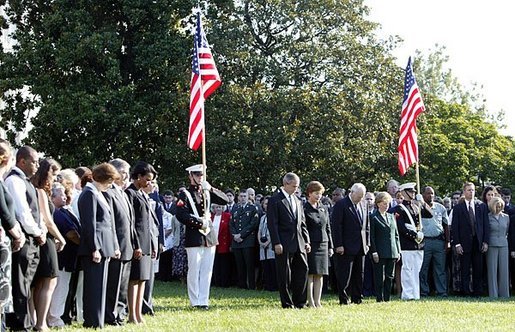 Honoring the memory of those who died during terrorist attacks on this day two years ago, President George W. Bush, Laura Bush, Vice President Dick Cheney and Lynne Cheney stand with White House staff for a moment of silence on the South Lawn 8:46 a.m., Thursday, Sept. 11, 2003. White House photo by David Bohrer