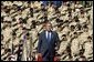 President George W. Bush walks on stage before addressing military personnel and their families at Ft. Stewart, Ga., Friday, Sept. 12, 2003. White House photo by Paul Morse