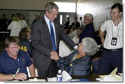 After delivering remarks about Hurricane Isabel, President George W. Bush personally thanks FEMA staff at the temporary operations center housed at the Virginia State Police Academy in Richmond, Va., Monday, Sept. 22, 2003. "There's a lot of neighborliness taking place in the state of Virginia and North Carolina and Maryland, where if somebody hurts and somebody's lonely, somebody needs help is finding refuge and solace because a fellow citizen has taken it upon him or herself to help somebody in need," said the President.  White House photo by Paul Morse