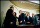 President George W. Bush signs the Do Not Call Registry in the Roosevelt Room Sept. 29, 2003. Pictured with the President are, from left, Rep. Edward Markey, D-Mass.; Rep. Fred Upton, R-Mich.; Federal Trade Commission Chairman Timothy Muris; Rep. Billy Tauzin, R-La. (behind President Bush); Federal Communications Commission Chairman Michael Powell; and Sen. Ted Stevens, R-Alaska. White House photo by Eric Draper