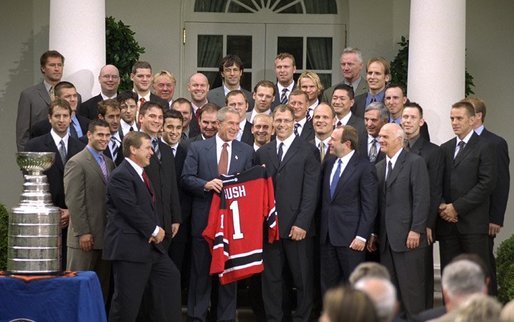 President George W. Bush poses with the 2003 Stanley Cup Champion New Jersey Devils ice hockey team Monday afternoon, September 29, 2003, in the Rose Garden. White House photo by Jennifer Smith.