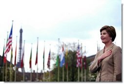 Laura Bush stands with her hand over her heart as the U.S. flag is raised in front of UNESCO headquarters Sept. 9, 2003, in Paris to mark the re-joining of the United States to the international organization. Mrs. Bush is the Goodwill Ambassador for the UNESCO Decade of Literacy.  White House photo by Susan Sterner