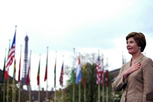 Laura Bush stands with her hand over her heart as the U.S. flag is raised in front of UNESCO headquarters Sept. 9, 2003, in Paris to mark the re-joining of the United States to the international organization. Mrs. Bush is the Goodwill Ambassador for the UNESCO Decade of Literacy. White House photo by Susan Sterner