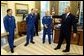 President George W. Bush shares a laugh with members of the International Space Station Expedition 6 Crew during their photo opportunity in the Oval Office Wednesday, Oct. 1, 2003. From left, are, Russian Flight Engineer Nikolai Budarin, Science Officer Donald Pettit, and Commander Kenneth Bowersox. Also pictured in background is NASA Administrator Sean O'Keefe. White House photo by Eric Draper.