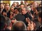 President George W. Bush embraces Brazilian Musician Alexandre Pires after his performance during the Celebration of Hispanic Heritage Month in the East Room, Thursday, Oct 2, 2003. White House photo by Tina Hager.