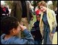 Mrs. Bush poses with children during her visit to the 2003 National Book Festival on the National Mall in Washington, D.C., Oct. 4, 2003. White House photo by Susan Sterner