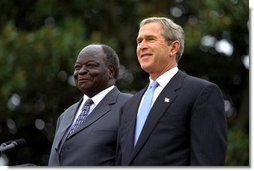 Presidents Bush and Kibaki watch the military review portion of the State Arrival Ceremonies on the South Lawn of the White House Monday, October 5, 2003.  White House photo by Susan Sterner