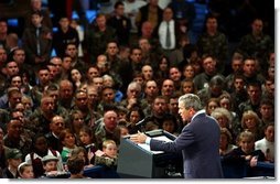 President George W. Bush delivers remarks to the New Hampshire Air National Guard, Army National Guard, Reservists and their families at Pease Air National Guard Base in Portsmouth, N.H., Thursday, Oct. 9, 2003. "Militia and volunteers and guardsmen have served from the Revolution to the Civil War, to World War II, to Desert Storm. Honor and service and courage are great New Hampshire traditions, and you're upholding those traditions," said the President in his remarks. White House photo by Tina Hager.