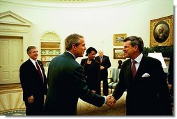 Discussing the progress in Iraq, President George W. Bush meets with Ambassador L. Paul Bremer, Presidential Envoy to Iraq, in the Oval Office Monday, Oct. 27, 2003. "Well, a lot of wonderful things have happened in Iraq since July, as you mentioned," said Ambassador Bremer to the media. "We have a cabinet now, with ministers actually conducting affairs of state. We have met all of our goals in restoring essential services. All the schools and hospitals are open. Electricity is back at pre-war levels."  White House photo by Tina Hager