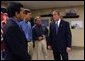 President George W. Bush meets with small business owners during a visit to CraneWorks' equipment warehouse in Birmingham, Ala., Monday, Nov. 3, 2003. Pictured with President Bush are Rom Reddy, CEO of Nexcel Synthetics, left, and brothers David, center, and Steve Upton, President and Vice President of CraneWorks. White House photo by Eric Draper