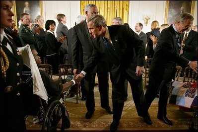 President George W. Bush speaks with Pvt. 1st Class Phillip Ramsey after signing The Emergency Supplemental Appropriations Act for Defense and for The Reconstruction of Iraq and Afghanistan in the East Room Thursday, Nov. 6, 2003. White House photo by Susan Sterner