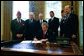 President George W. Bush signs H.R. 3365, The Military Family Tax Relief Act of 2003 in the Oval Office on Veterans Day, Nov. 11, 2003. The legislation provides tax-relief for military and Foreign Service personnel. Pictured with the President are, from left: John Brieden, American Legion National Commander; Congressman James McGovern, R-Mass.; Congressman Rick Renzi, R-Ariz.; Secretary of Veterans Affairs Anthony Principi; Jim Mueller, Veterans of Foreign Wars, Junior Vice Commander-in-Chief; and Admiral Norb Ryan, Military Officers Association of America. White House photo by Eric Draper.