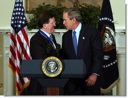 President George W. Bush congratulates NATO Secretary General Lord George Robertson after awarding him the Presidential Medal of Freedom during a ceremony in the Roosevelt Room Wednesday, Nov. 12, 2003.  White House photo by Tina Hager