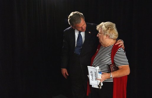 President George W. Bush embraces Loretta De Maintenon after meeting with seniors about his commitment to add prescription drug benefits to Medicare during a visit to Orlando, Fla., Thursday, Nov. 13, 2003. White House photo by Tina Hager