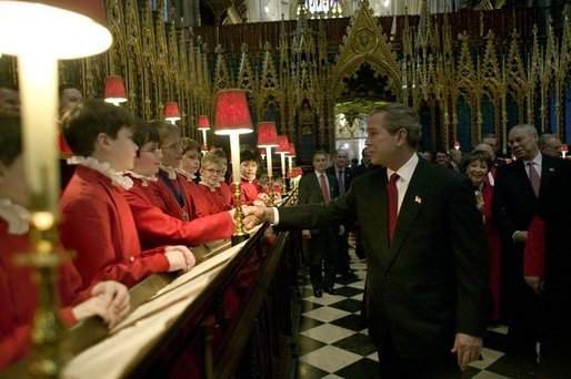 After listening to the Westminster Abbey Choir perform, President George W. Bush greets one of the younger choir members during his and Mrs. Bush's tour of the abbey Thursday, Nov. 20, 2003. White House photo by Eric Draper.