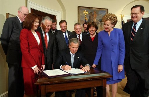 President George W. Bush signs H.R. 2622, the Fair and Accurate Credit Transactions Act of 2003, into law during a ceremony in the Roosevelt Room Thursday, December 4, 2003. White House photo by Tina Hager.