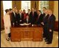 President George W. Bush pauses before signing the Controlling the Non-Solicited Pornography and Marketing Act of 2003, which establishes a framework of administrative, civil and criminal tools to help America’s consumers, businesses and families combat SPAM, in the Oval Office Tuesday, Dec. 16, 2003. Pictured with the President are from left to right: Rep. Heather Wilson, (R, NM); Garry Betty, President and CEO of Earthlink; Rep. Edward Markey (D, MA); Rep. Rick Boucher (D, VA); Sen. Conrad Burns (R, MT); Rep. Melissa Hart (R, PA; Sen. Bill Frist (R, TN); Sen. Ron Wyden (D, OR); Rep. Chris Cannon (R, UT); Jonathan Miller, Chairman and CEO of America Online; Maynard Webb, Chief Operating Officer of eBay; Rep. Gene Green (D, TX). White House photo by Tina Hager.