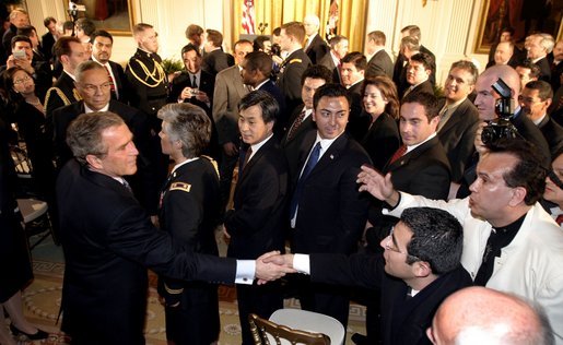 President George W. Bush greets enthusiastic audience members after discussing his immigration policy in the East Room Wednesday, Jan. 7, 2004. White House photo by Paul Morse.