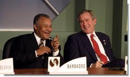 President George W. Bush talks with the Prime Minister Owen Arthur of Barbados during the inaugural ceremony of the Special Summit of the Americas in Monterrey, Mexico, Jan. 12, 2004.  White House photo by Paul Morse