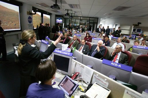 Vice President Dick Cheney listens to a briefing on NASA's Spirit and Opportunity Expeditions to Mars in the Jet Propulsion Laboratory's mission control room in Pasadena, Calif., Jan 14, 2004. JPL developed and now remotely controls the rover Spirit since it landed on the planet Jan. 3, 2004. Sitting next to Vice President Cheney are, from left, Dr. Frederick D. Gregory, NASA Deputy Administrator, Dr. David Baltimore, President of the California Institute of Technology and Dr. Charles Elachi, the Director of the Jet Propulsion Laboratory. White House photo by David Bohrer