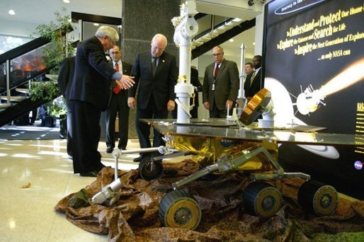 Vice President Dick Cheney looks at a replica of NASA's rover Spirit while touring the Jet Propulsion Laboratory in Pasadena, Calif., Jan. 14, 2004. Spirit, developed and controlled at the laboratory, will explore Mars' Gusev Crater to determine whether the planet ever contained water and if it could sustain life. White House photo by David Bohrer