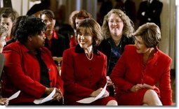 Laura Bush and Assistant Secretary for Health (acting) Dr. Cristina Beato, center, listen to heart attack survivor Joyce Cullen. Ms. Cullen spoke about her experiences as a survivor during a White House ceremony held as part of the national Heart Truth campaign to raise awareness of heart disease as the number-one killer of women in the United States. Monday, Feb. 2, 2004.  White House photo by Susan Sterner