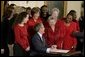 President George W. Bush and Laura Bush laugh with survivors of heart disease as the President signs the American Heart Month proclamation at the White House Monday, Feb. 2, 2004. White House photo by Paul Morse