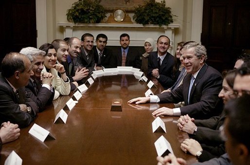 President George W. Bush meets with 25 Iraqi Fulbright Scholars in the Roosevelt Room Tuesday, Feb. 3, 2004. Reestablished in October of 2003, the Fulbright Program offers its scholarship recipients the opportunity to study at American universities. White House photo by Paul Morse.