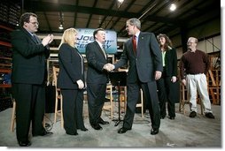 President George W. Bush greets the stage participants at the end a conversation on the economy at SRC Automotive in Springfield, Mo., Monday, Feb. 9, 2004. From left, they are Mike Sadler, President of Custom Manufacturing and Polishing; Tricia Derges, CEO of Mostly Memories; Jack Stack CEO of SRC Automotive; Teresa Noblitt, SRC Automotive accountant; and Gary Brown, SRC Automotive Warehouse Supervisor.  White House photo by Eric Draper