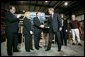 President George W. Bush greets the stage participants at the end a conversation on the economy at SRC Automotive in Springfield, Mo., Monday, Feb. 9, 2004. From left, they are Mike Sadler, President of Custom Manufacturing and Polishing; Tricia Derges, CEO of Mostly Memories; Jack Stack CEO of SRC Automotive; Teresa Noblitt, SRC Automotive accountant; and Gary Brown, SRC Automotive Warehouse Supervisor. White House photo by Eric Draper