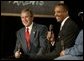 President George W. Bush and John Butler, President of Archbishop Carroll High School, listen to the audience during a conversation on parental options and school choice at Archbishop Carroll High School in Washington, D.C., Friday, Feb. 13, 2004. White House photo by Paul Morse