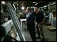 President George W. Bush participates in a tour of Nu-Air Manufacturing Company with employee Marshall Hartley in Tampa, Florida, Monday, Feb. 16, 2004. White House photo by Eric Draper