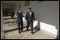 German Chancellor Gerhard Schroeder walks with President George W. Bush along the colonnade in the Rose Garden Friday, Feb. 27, 2004. White House photo by Eric Draper