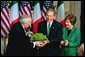 President George W. Bush and Laura Bush receive a bowl of Shamrock from Ireland's Prime Minister Bertie Ahren during the annual ceremony celebrating St. Patrick's Day in the Roosevelt Room Wednesday, March 17, 2004. White House photo by Tina Hager.