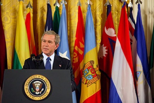 President George W. Bush speaks in the East Wing to mark the one-year anniversary of operation Iraqi Freedom and to highlight the efforts of his administration and 91 nations to ensure peace and stability in Iraq, Afghanistan and the Greater Middle East Friday, March 19, 2004. White House photo by Susan Sterner.