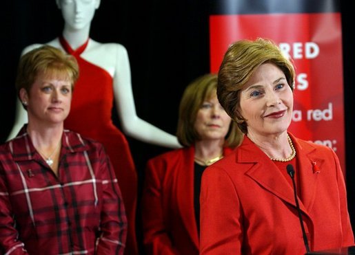 During a trip to Chicago, Mrs. Bush discusses the Red Dress Project Tuesday, March 23, 2004. Behind Mrs. Bush are dresses designed by American fashion designers which are touring the country to raise awareness of heart disease in women. White House photo by Tina Hager