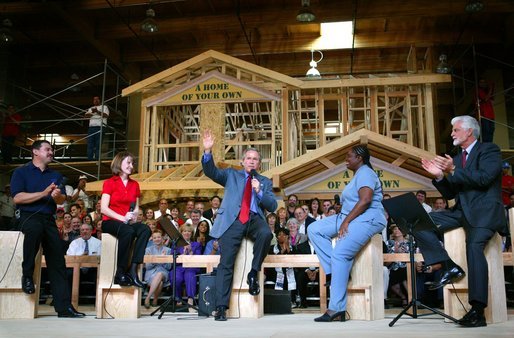 President George W. Bush acknowledges the audience at the conclusion of a conversation on homeownership at the Carpenters Training Center in Phoenix, Ariz., Friday, March 26, 2004. Pictured on stage with the President, from left, are construction foreman Jorge Sotelo, first-time homebuyer Emily McElhaney, first-time homebuyer Monica Sims and Doug McCarron, General President of the United Brotherhood of Carpenters and Joiners of America. White House photo by Eric Draper