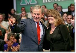 President George W. Bush acknowledges the family of stage participant and student Rina Angus during a conversation on job training at Marshall Community & Technical College in Huntington, W.Va., Friday, April 2, 2004.  White House photo by Eric Draper