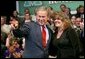 President George W. Bush acknowledges the family of stage participant and student Rina Angus during a conversation on job training at Marshall Community & Technical College in Huntington, W.Va., Friday, April 2, 2004. White House photo by Eric Draper