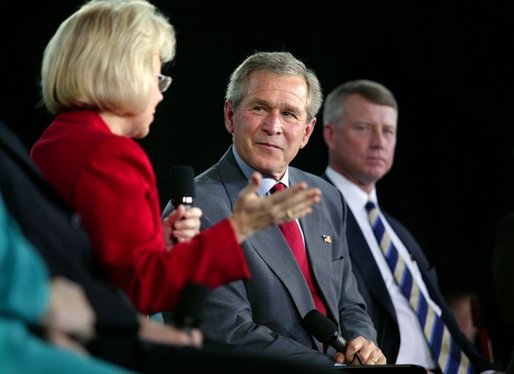 President George W. Bush listens to Dr. Kathy Matlock during a conversation on job training and the economy at South Arkansas Community College in El Dorado, Ark., Tuesday, April 6, 2004. Dr. Matlock is the President of South Arkansas Community College. White House photo by Eric Draper