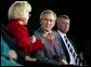 President George W. Bush listens to Dr. Kathy Matlock during a conversation on job training and the economy at South Arkansas Community College in El Dorado, Ark., Tuesday, April 6, 2004. Dr. Matlock is the President of South Arkansas Community College. White House photo by Eric Draper