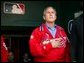 President George W. Bush stands for the playing of the national anthem in the St. Louis Cardinal’s dugout during their season opener against the Milwaukee Brewers Monday, April 5, 2004. As part of the opening ceremonies for the 2004 baseball season, President Bush threw out the first pitch. White House photo by Eric Draper