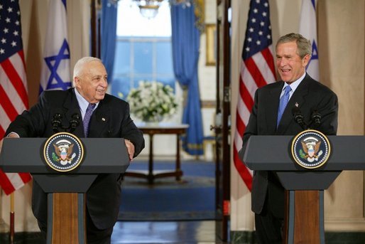 President George W. Bush and Israeli Prime Minister Ariel Sharon during a press conference in the Cross Hall of the White House on April 14, 2004. White House photo by Paul Morse.